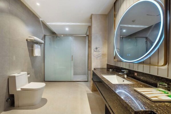 A modern bathroom with a toilet, sink, and shower. - Vienna Classic Hotel (Hefei Shushan) (Hefei)