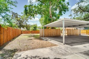 Relax in a serene outdoor space surrounded by lush greenery and a wooden fence.