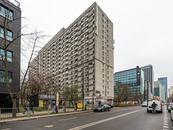 A tall, multi-story building with numerous windows and balconies, likely a residential or hotel building.