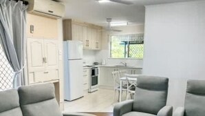 A modern living room with a sofa, armchairs, and a coffee table. - Beachside on Burkitt - duex (Bargara)