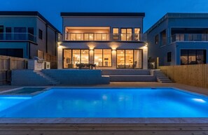 Outdoor pool, a heated pool - Newly Built Large Bayfront Home w Pool, only 15 Min from SPI (Port Isabel)