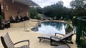 A pool area with lounge chairs and a building labeled "Cliff Resort".