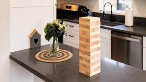A kitchen with a wooden block tower, a vase with flowers, and a woven placemat on the counter. - Spacious 4BR Home w/ Cozy Fireplace, Pool & Easy Access to LA Attractions (Calabasas)