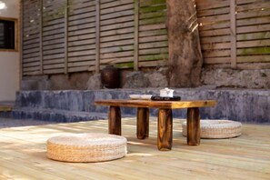 A wooden table with a woven stool in front, set on a bamboo floor. - No.54·Nanyang Old Villa (Quanzhou)
