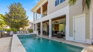 A two-story house with a swimming pool, outdoor seating, and a covered patio area. - Welcome to The Dream Getaway (Kissimmee)