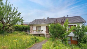 A house with a paved pathway leading to the entrance, surrounded by lush greenery and a clear sky. - Holiday Home 'Le Château D'Eau' with Private Terrace, Private Garden and Wi-Fi (Wissembourg)