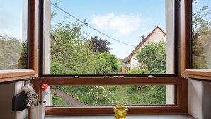 A kitchen with a window, a sink, and a metal container with brushes. - Holiday Home 'Le Château D'Eau' with Private Terrace, Private Garden and Wi-Fi (Wissembourg)