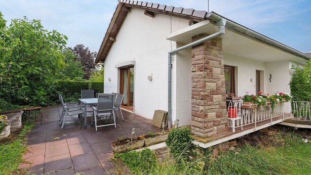 A house with a patio, outdoor furniture, and a stone pillar. - Holiday Home 'Le Château D'Eau' with Private Terrace, Private Garden and Wi-Fi (Wissembourg)