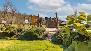 A playground with climbing structures and a slide, surrounded by greenery and trees. - Mobile Home O'Hara 834T – Family Getaway: Shared Pools & Near Sarlat (Bouzic)