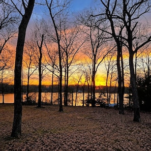 A forested area with trees and a body of water in the background. - Playin Hooky on Lake Fork-Waterfront-Boat Ramp (Quitman)