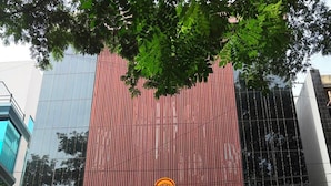 A hotel with signage for 'ALCOTT HOTEL & RESORTS' and 'ANDHRA KITCHEN'.
