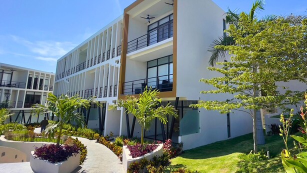 A modern building with a flat roof, large windows, and a balcony. - Araquuna gated community, 2 bd condo close to PV, Sayulita, Bucerias (Mezcales)