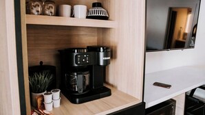 A kitchenette with a coffee maker, jars, and a small plant. - M2 - Double Queen room #4 (Dalhousie)