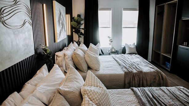 A bedroom with two beds, a large abstract painting, and a view of the outdoors. - M2 - Double Queen room #4 (Dalhousie)