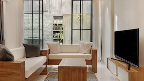 Una sala moderna con un sofá, una mesa de centro y un televisor.