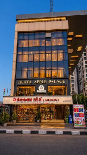A hotel named 'Hotel Apple Palace' with a modern facade, large windows, and a visible entrance. - Hotel Apple Palace Surat (Surat)