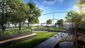 A modern outdoor space with a grassy area, wooden benches, and a metal fence.