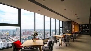 A modern office space with large windows offering a city view.