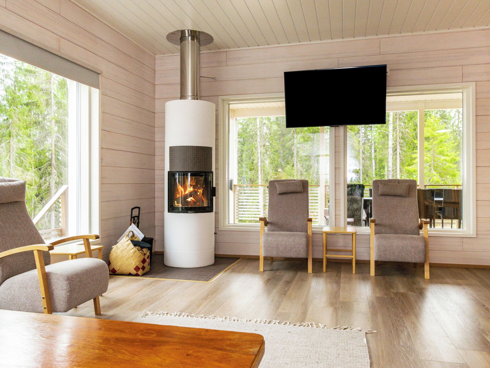 Una sala de estar acogedora con chimenea, asientos cómodos y ventanas amplias.