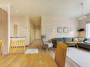 A modern interior with a dining area, a sofa, and a kitchen in the background. - Vintteri by Interhome (Ikaalinen)