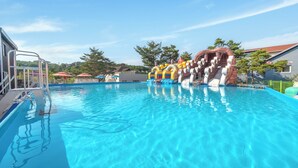 A swimming pool with inflatable slides and a lifeguard stand. - Gyeongju The Stay Spa Pension (Gyeongju)