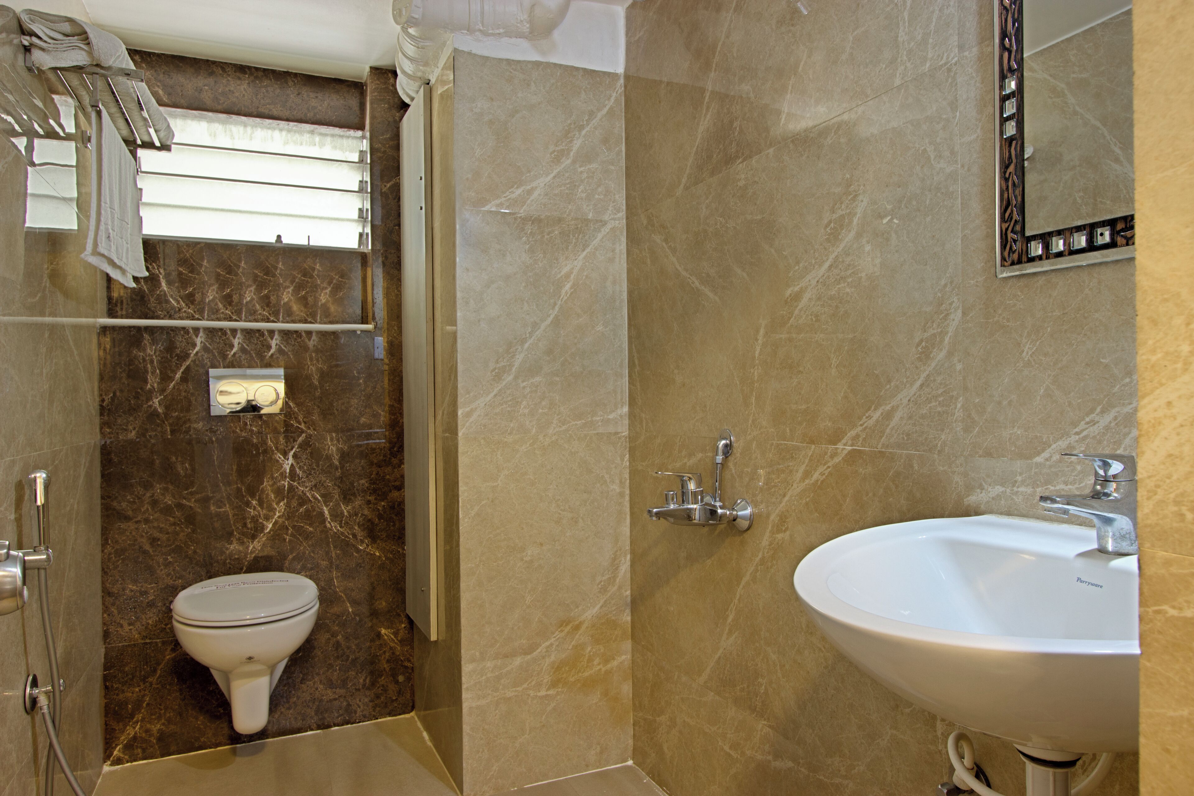 A bathroom with a toilet, sink, and shower.