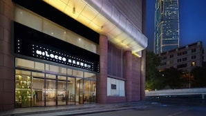 A modern building with a large illuminated sign reading "Miloco." - Milegu Hotel (Changsha)