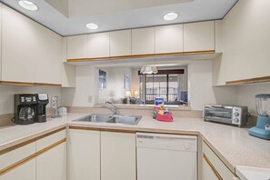 Enjoy cooking in this well-equipped kitchen with a dishwasher, double sink, and coffee maker.