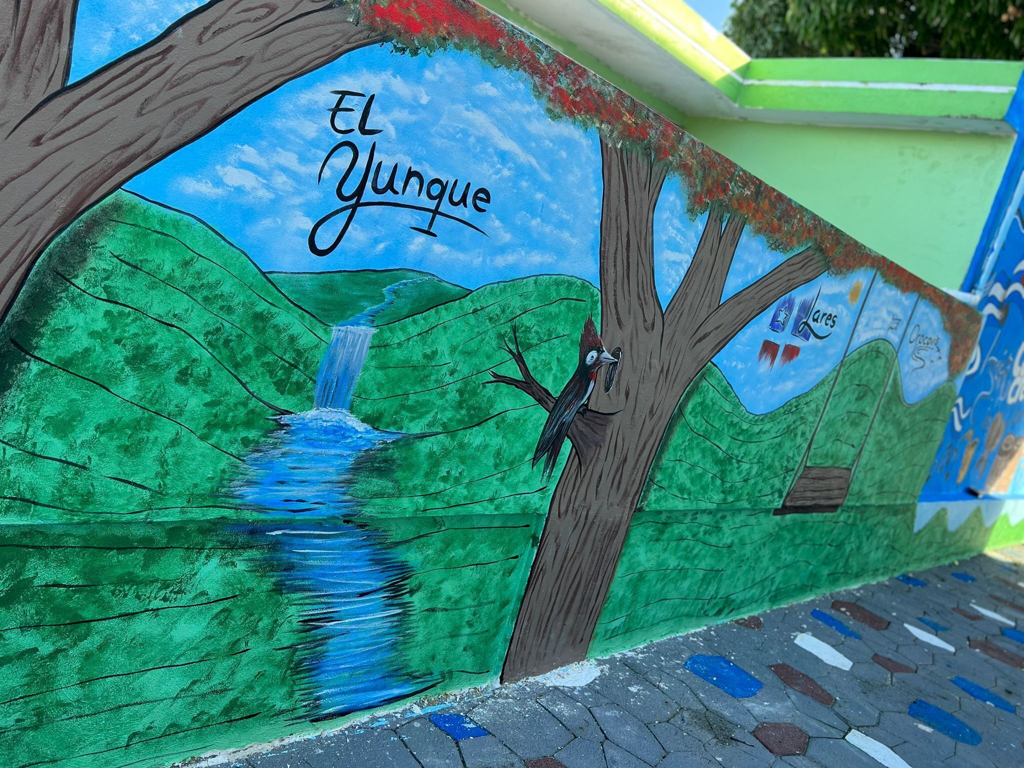 A mural with a tree, a waterfall, and the text "El Yunque".