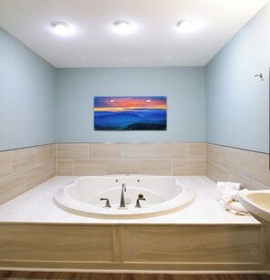 Jetted bath, hair dryer, towels, toilet paper