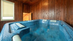 A hot tub in a wooden room with a window and a door. - Gapyeong Solle Spa Pension (Gapyeong)