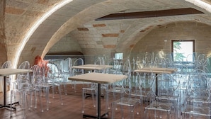 An interior with arched ceilings, clear plastic chairs, and tables, and a self-check-in kiosk. - Bed & Breakfast in Maglie with 1 bedrooms sleeps 2 (Maglie)