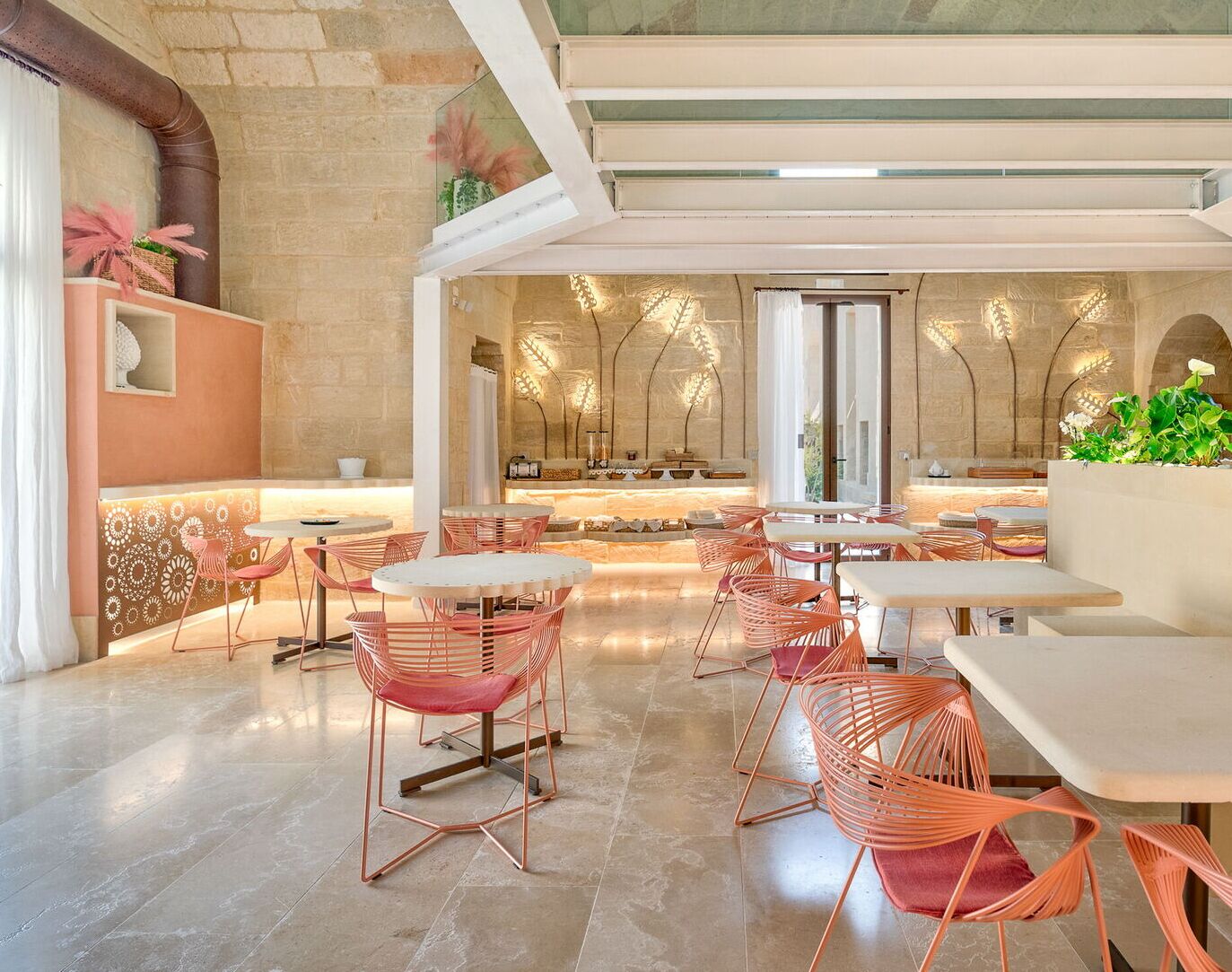 A modern dining area with round tables and chairs, a bar area, and a view of the outdoors.