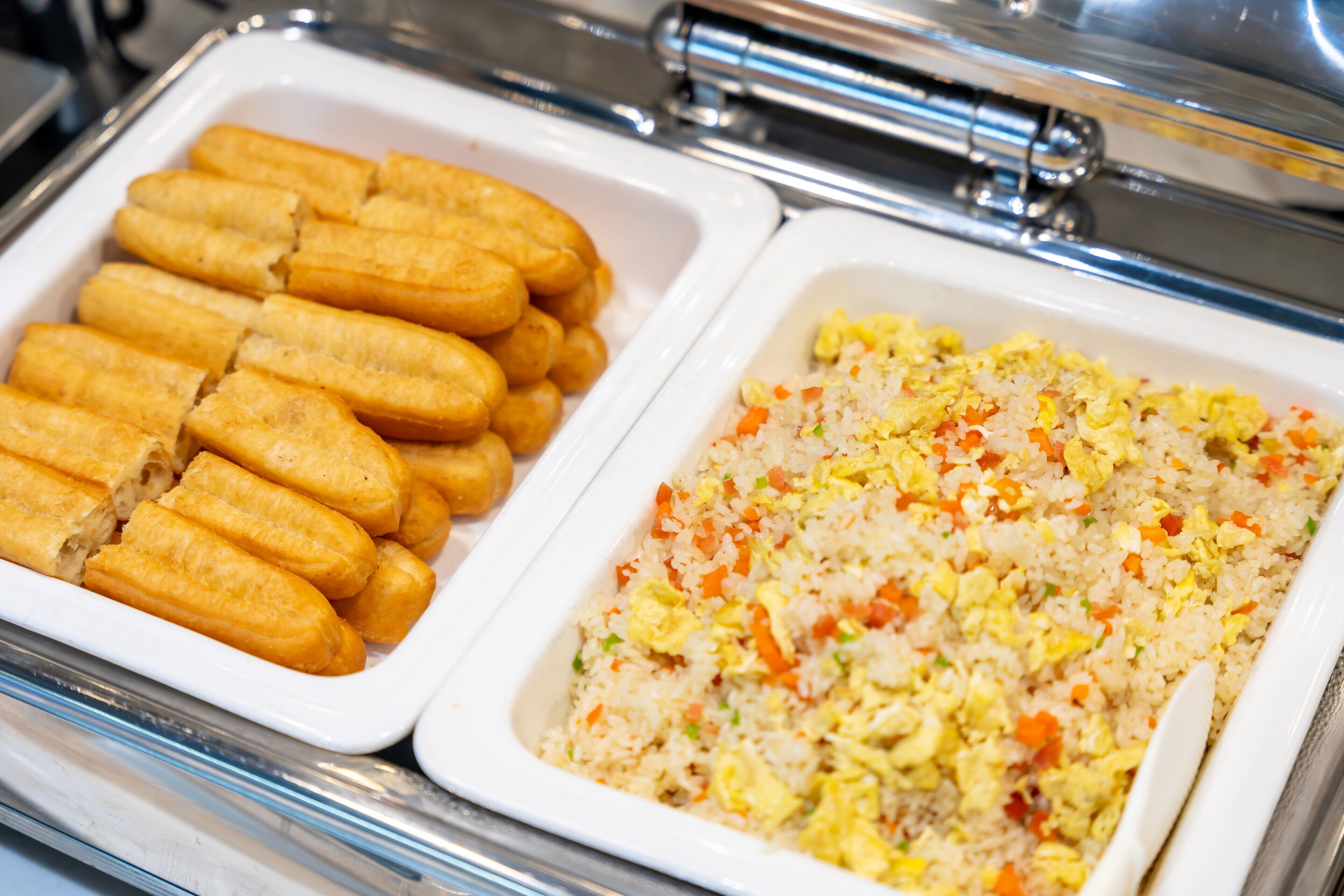 A buffet with fried items and fried rice.