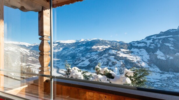 A mountain view from a wooden balcony with snow-covered peaks and clear skies. - Chalet in Mayrhofen near Ski Slopes (Hippach im Zillertal)