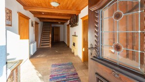 A hallway with wooden ceiling and walls, a staircase, and a door with a glass panel. - Chalet in Mayrhofen near Ski Slopes (Hippach im Zillertal)