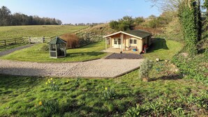 Ein kleines, eingeschossiges Haus mit Veranda und umzäunter Garten.