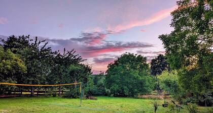 Vacation apartment in a cozy farmhouse by the bathing lake with large garden and sauna