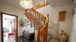 A staircase with wooden balusters, a desk with papers, and a wall with framed photos. - We have ski slopes. The hike up to La Covatilla takes 5 minutes. (San Bartolomé de Béjar)