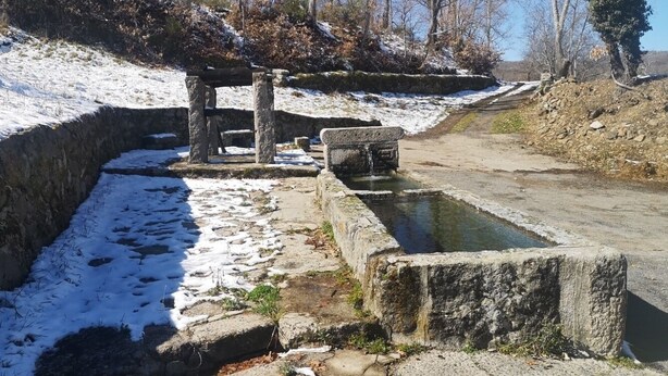 A stone structure with a water feature, surrounded by snow-covered ground and trees. - We have ski slopes. The hike up to La Covatilla takes 5 minutes. (San Bartolomé de Béjar)