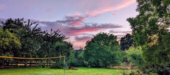 Vacation apartment in a cozy farmhouse by the bathing lake with large garden and sauna