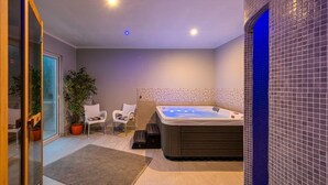 A modern bathroom with a hot tub, a glass door leading outside, and a potted plant. - Apartment in Drenje with Stunning Sea View (Drenje)