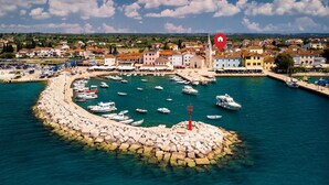 A coastal town with a marina, boats, and a lighthouse. - House in Fažana near Rock Beach (Fažana)