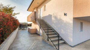 A modern building with a stone staircase leading to a balcony. - Lovely family bungalow with private pool (Valbandon)