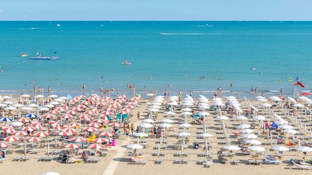 A beach with numerous umbrellas and sun loungers, indicating a beach resort setting. - Bright escape near the beach (Bibione)
