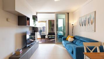 Deluxe Apartment | Living area | 55-inch Smart TV with digital channels