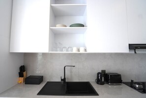 Fridge, stovetop, toaster, dining tables