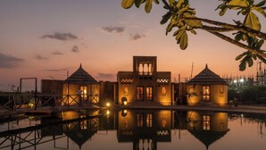 A building with a central courtyard and a pool reflecting its structure.