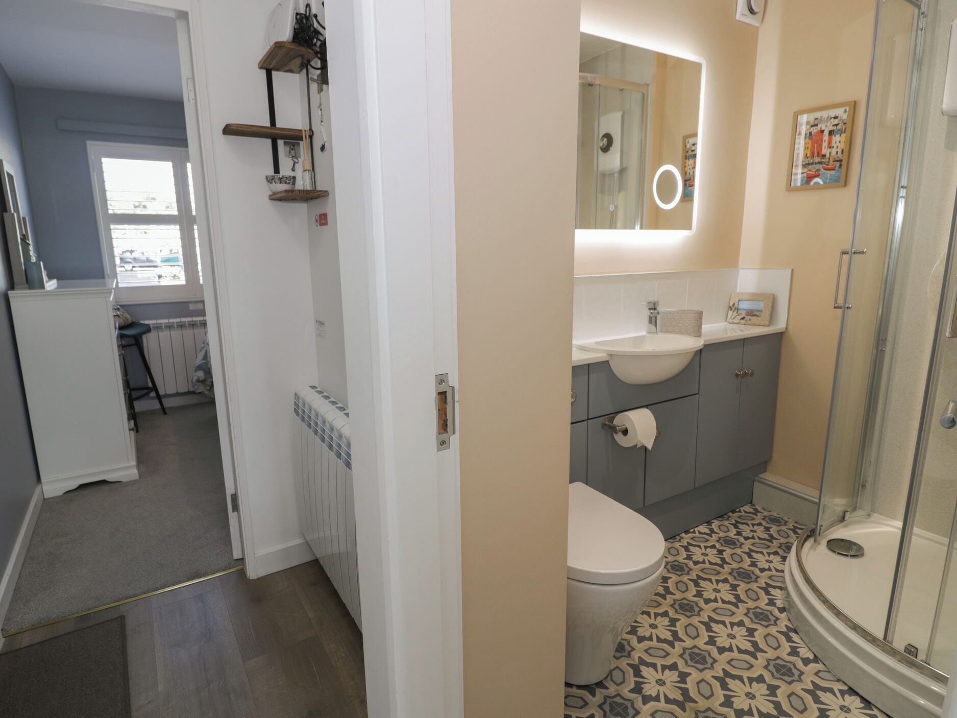 A bathroom with a toilet, sink, and shower.