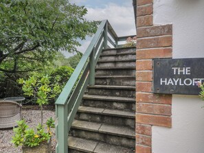 A staircase leading to a building with a sign that reads 'THE HAYLOFT'.